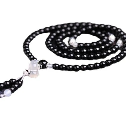 Black agate 108 beads bracelet with geometric shapes and numeric markers on unisex wrist