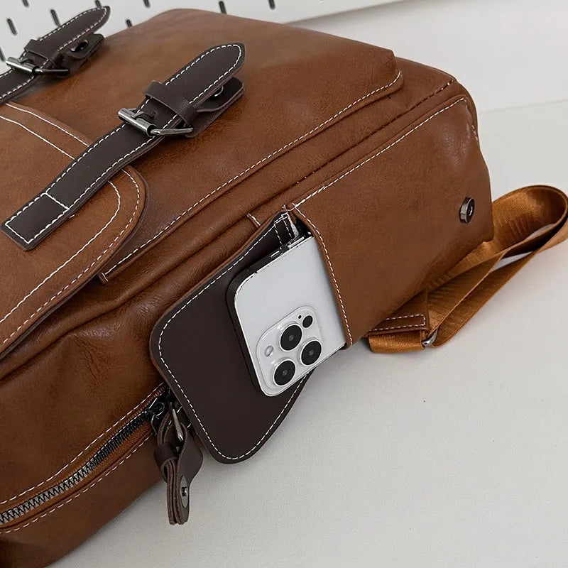 Retro leather travel backpack in black, dark brown, or brown with curved shoulder straps and 20-35L capacity