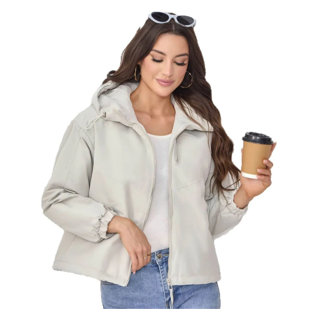 Grey women's loose-fit hooded polyester shell jacket with long sleeves on a hanger.