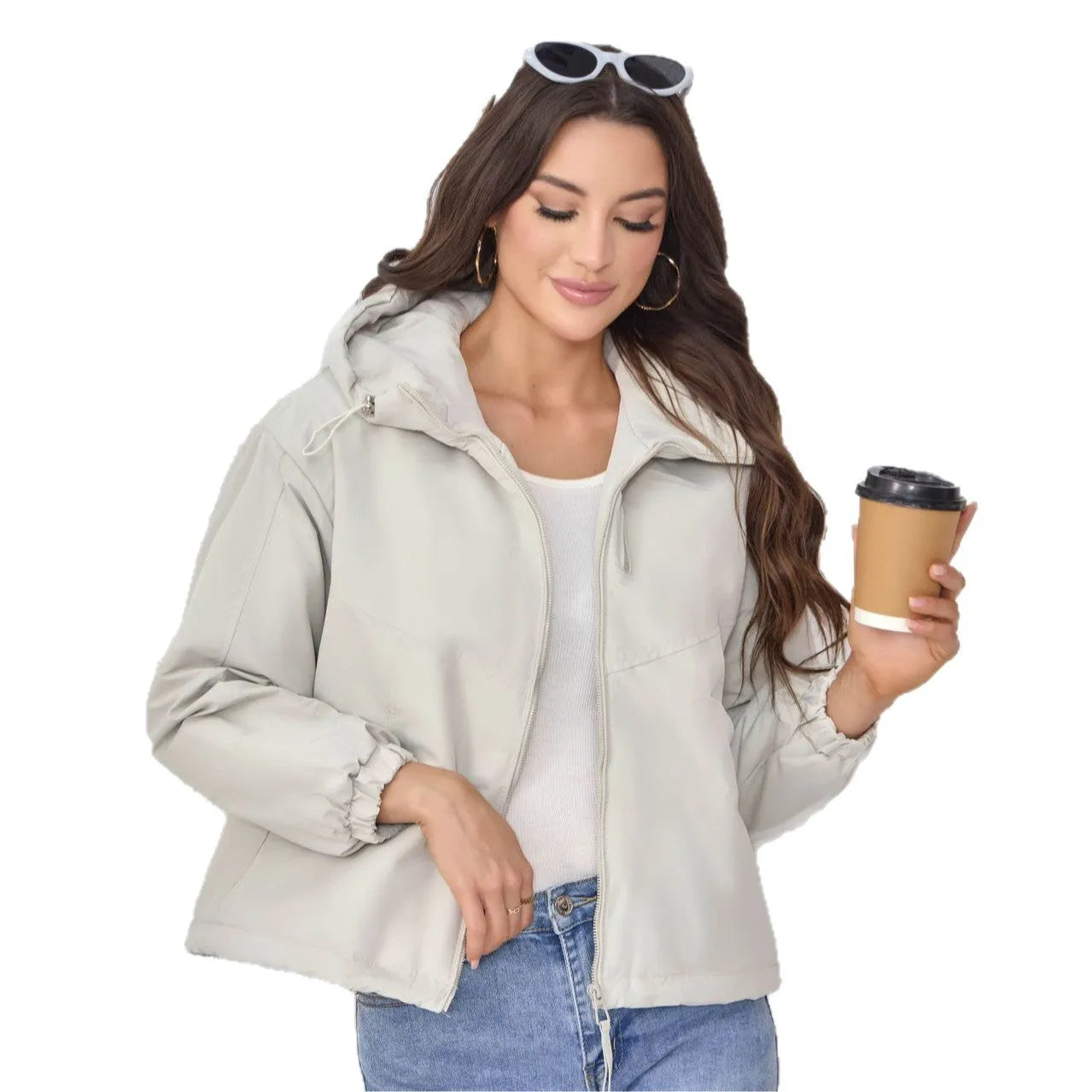 Grey women's loose-fit hooded polyester shell jacket with long sleeves on a hanger.