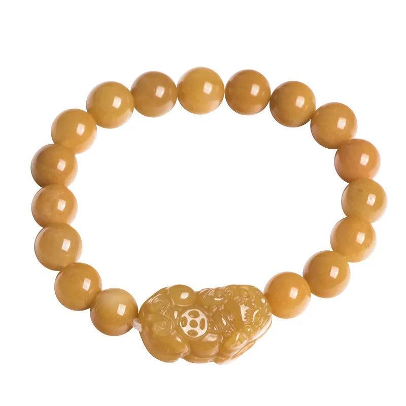 Golden Thread Jinsi Jade bracelet with a carved fortune coin and round jade beads in two size options.
