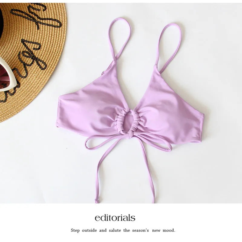 Women's bikini swimsuit with tied bow detail and split front design in solid colour
