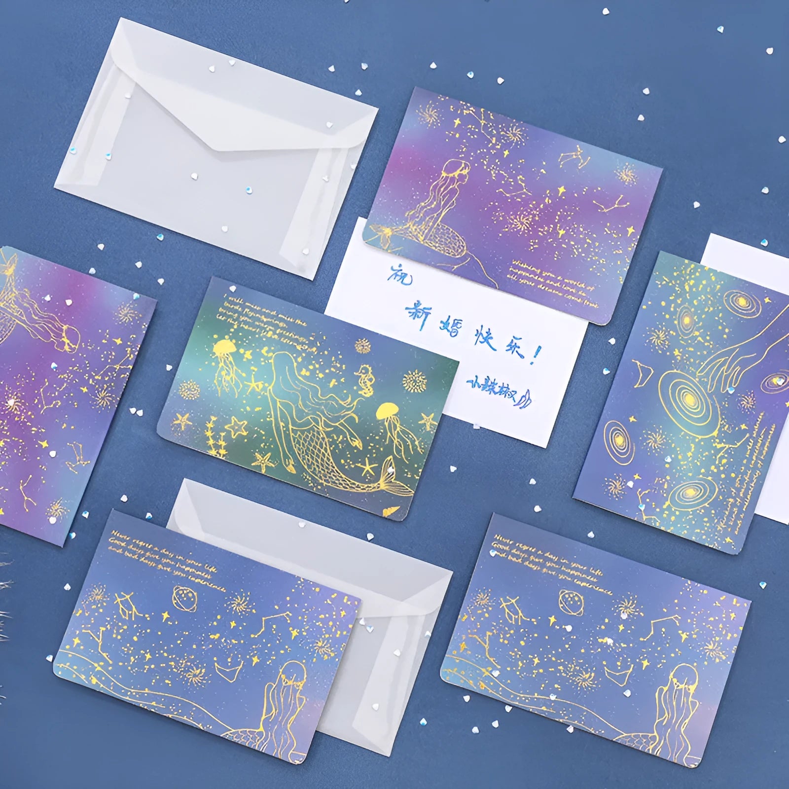 Set of three foldable sulfuric acid paper greeting card envelopes with bronzing, in celestial colours.
