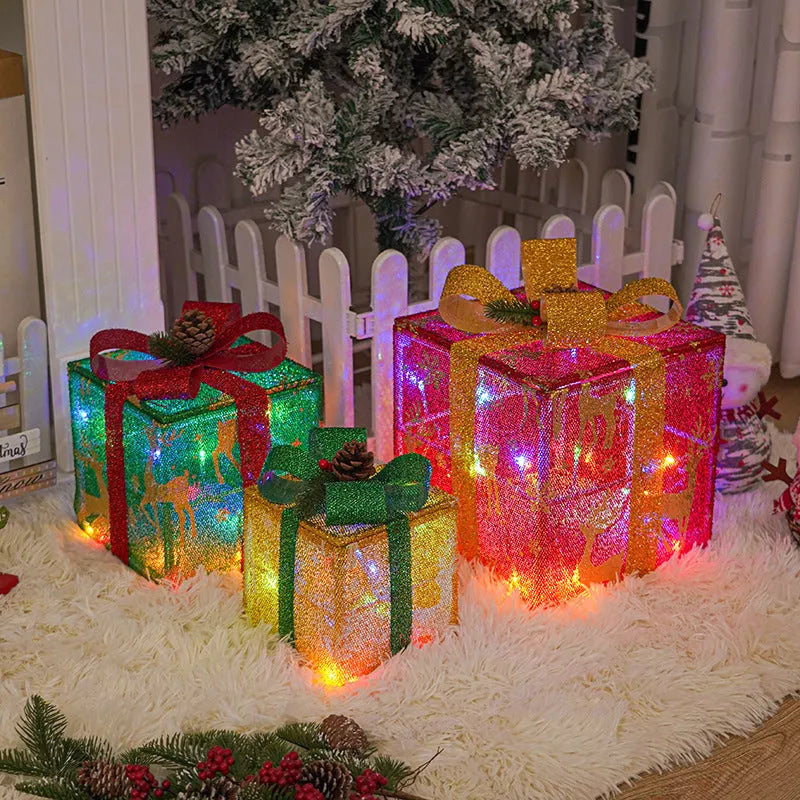 Set of three LED lighted Christmas gift boxes with red bows, showing warm white and multicolour light modes for outdoor holiday decor.