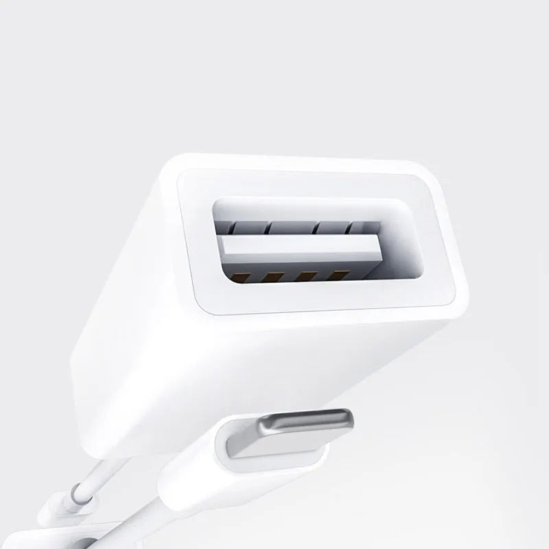 Apple OTG adapter cable in white plastic with Lightning connector and USB port