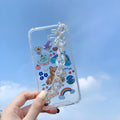 iPhone mobile phone case with a bear chain and pendant in a cartoon style.