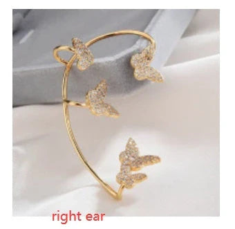 Sparkling zircon butterfly ear cuffs in gold-toned metal, featuring a delicate and elegant design for stylish accessorizing