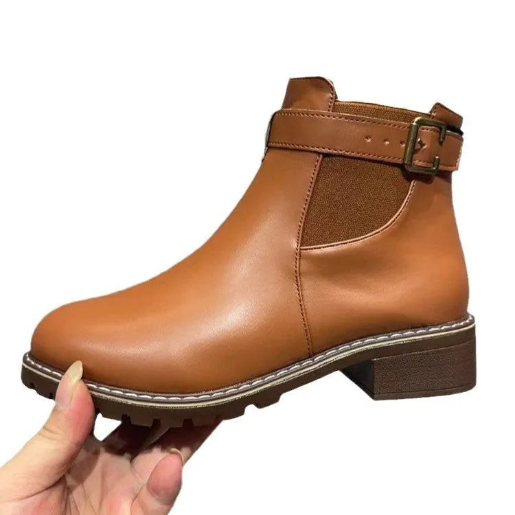 Women's round toe ankle boots with a belt buckle detail on the upper, shown in black.