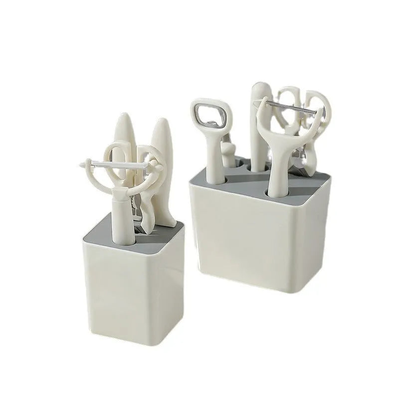 Six-piece white stainless steel kitchen gadget set arranged on a neutral background