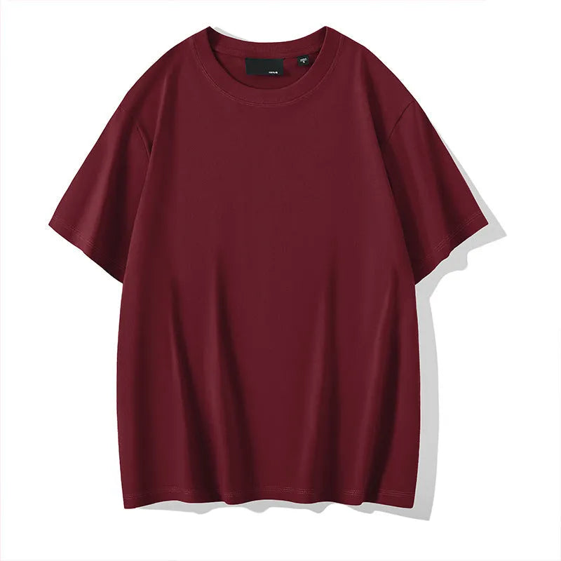 Man wearing a solid colour loose-fit cotton T-shirt with drop shoulder sleeves.