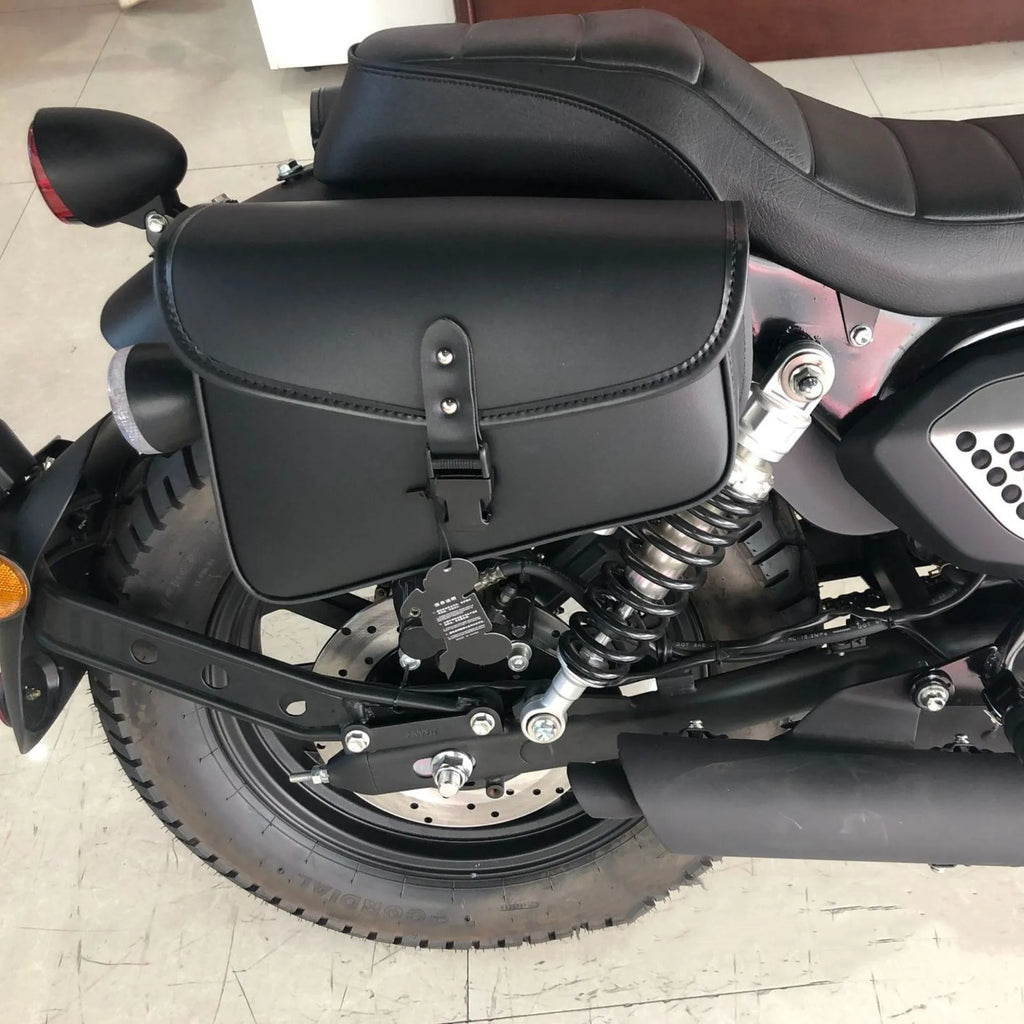 Black PU leather motorcycle swingarm saddlebag mounted on a Harley Sportster rear wheel assembly.