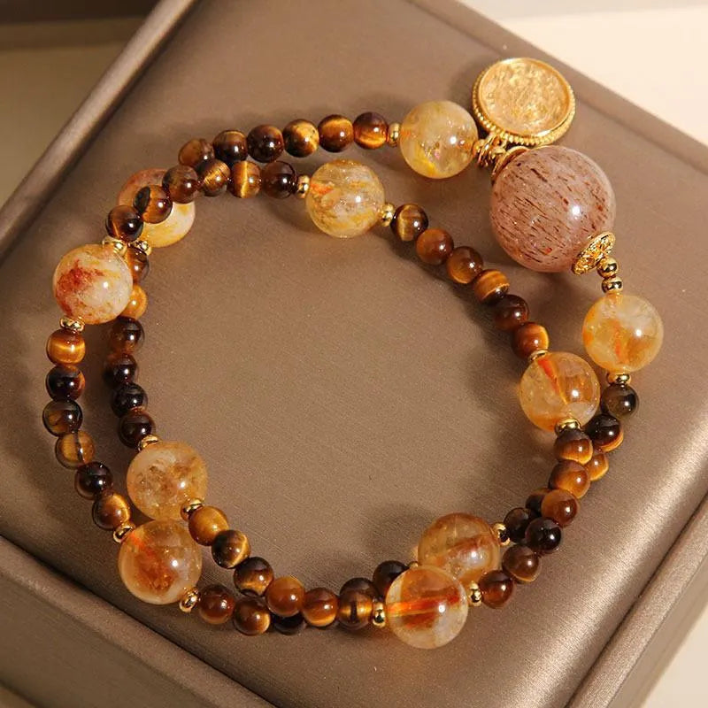 Double circle natural citrine tiger-eye bracelet with yellow tower crystal on white background