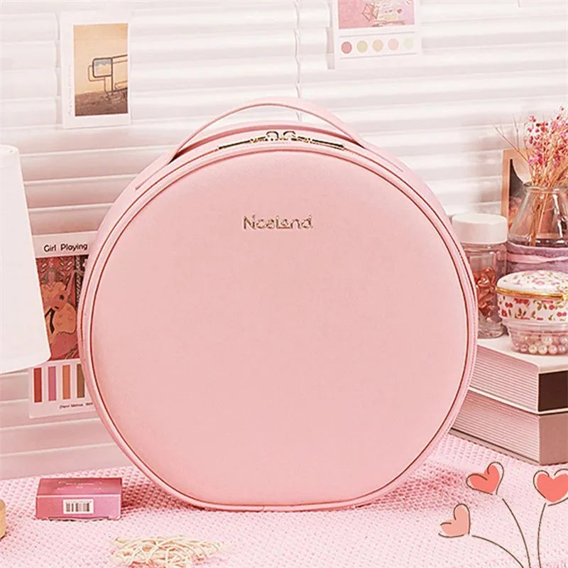 Round pink PU leather LED makeup bag open showing internal mirror, lights, and lattice partitions.