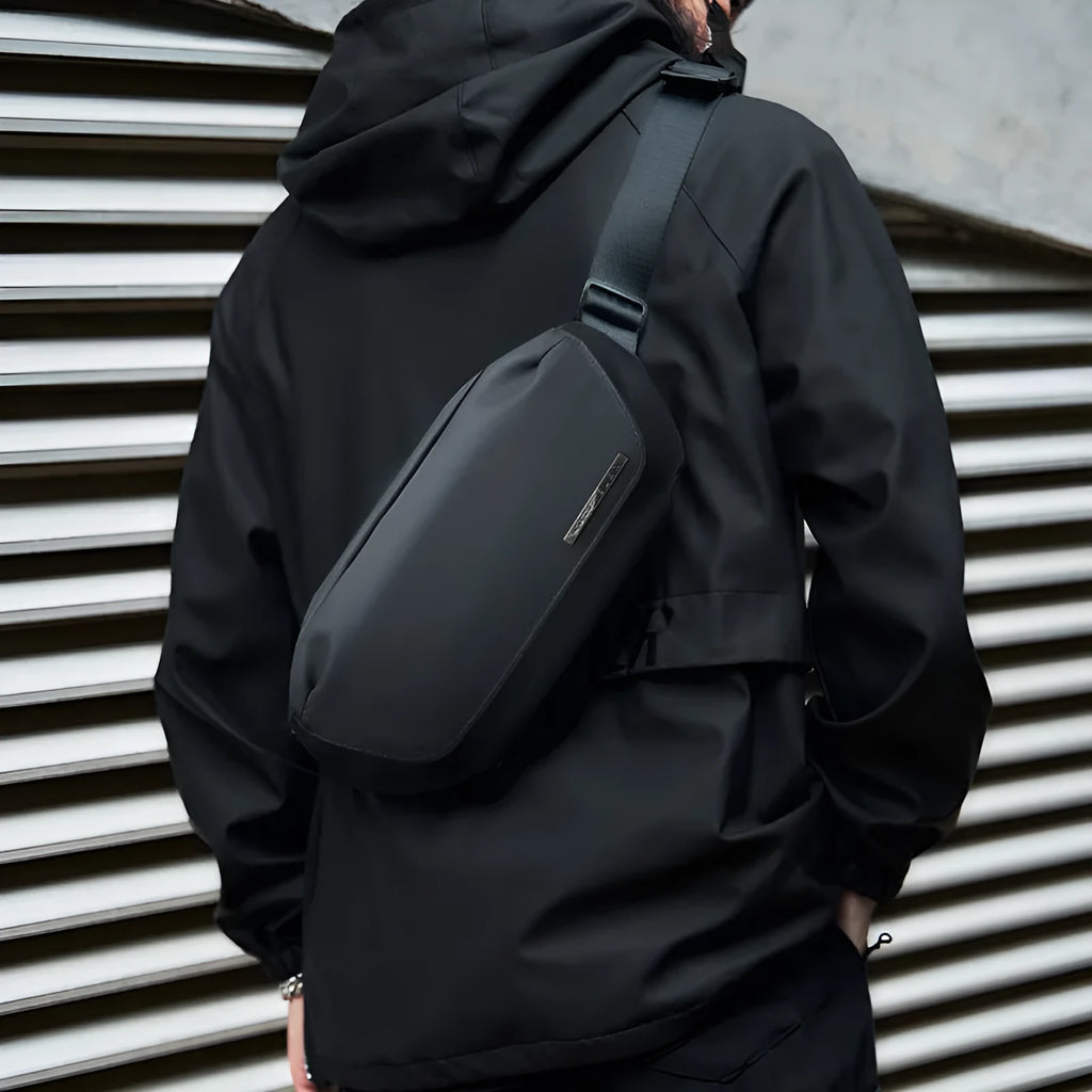 Black Oxford cloth men's messenger bag with cross-body strap and visible stitching.