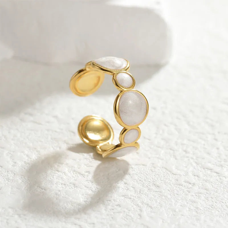 Adjustable stainless steel geometric ring with electroplated finish shown on hand
