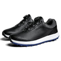 Men's white and black casual low-top golf shoes with breathable upper and traction sole.