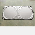 Silver reflective car sunshade unrolled showing 190cm by 90cm size next to its cloth storage bag.
