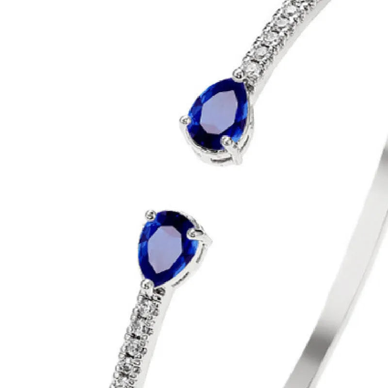 Personalised copper bracelet with multi-zircon inlay, shown in white and blue colour options