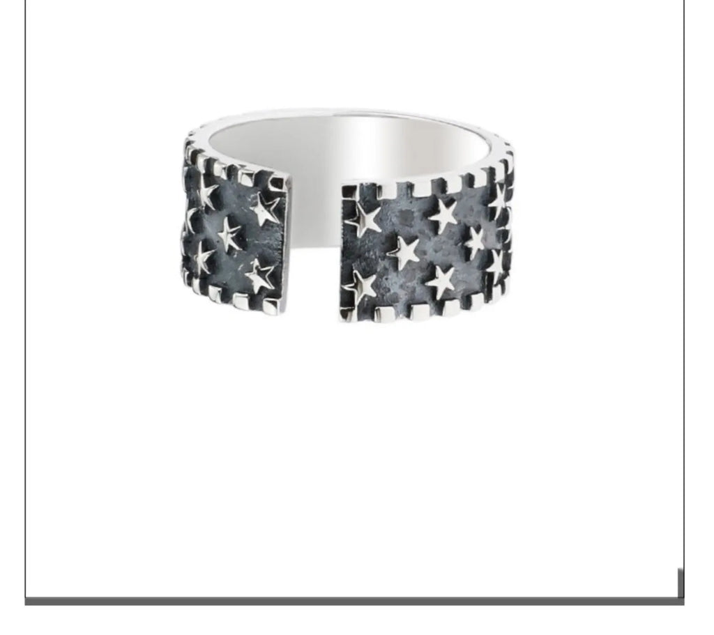 Adjustable sterling silver ring with geometric five-pointed star design on finger