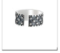Adjustable sterling silver ring with geometric five-pointed star design on finger