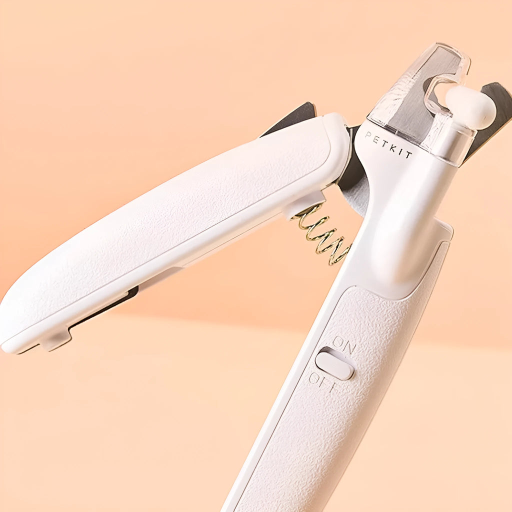 White LED pet nail clippers with a transparent anti-splash guard and an integrated nail file on a grey background.