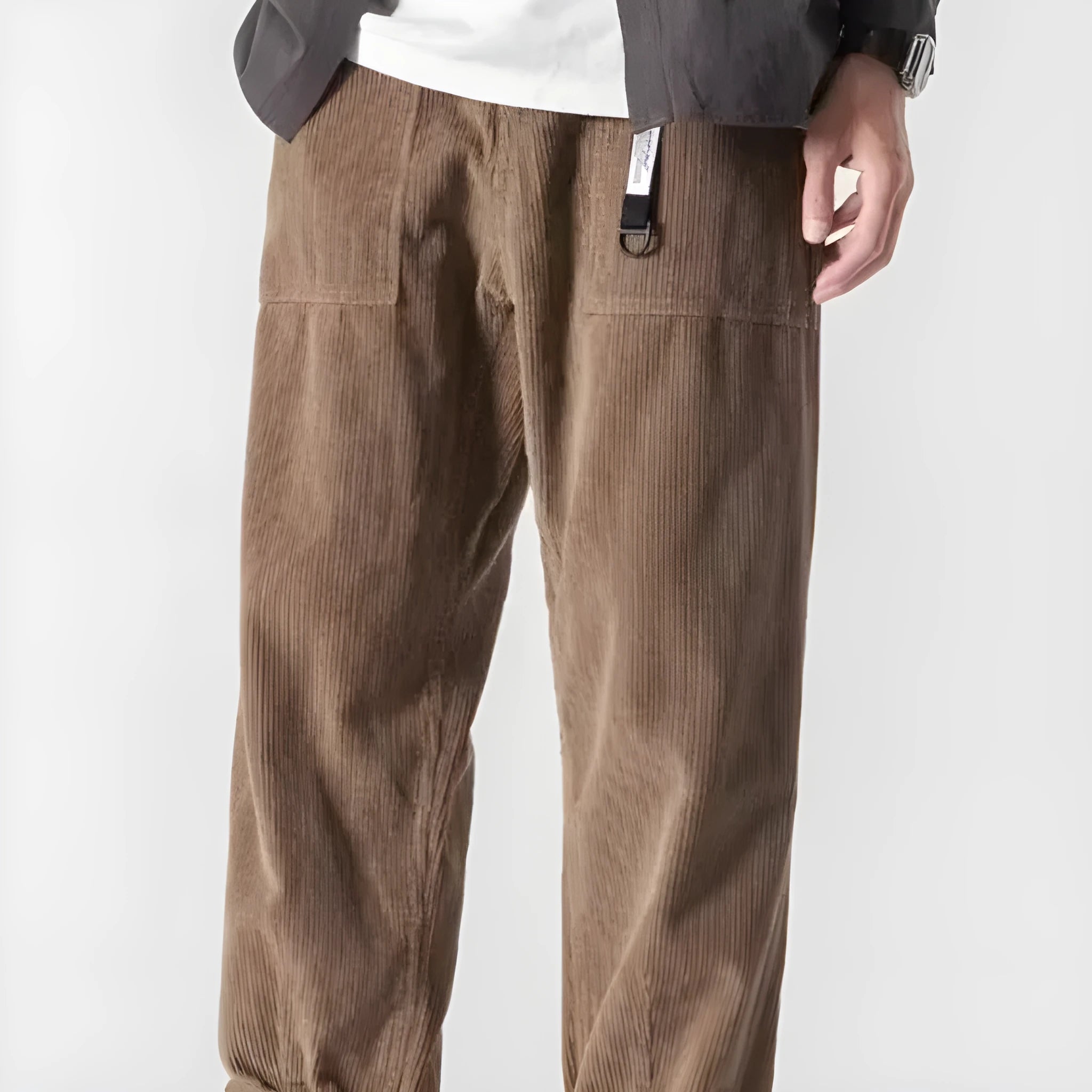 Man wearing loose straight leg tapered trousers in dark grey, showing relaxed fit and straight leg opening.