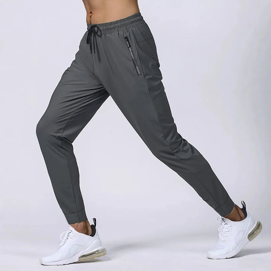 Men's jogging sports pants in nylon blend, mid waist loose fit, available in black gray khaki blue sizes L to 7XL