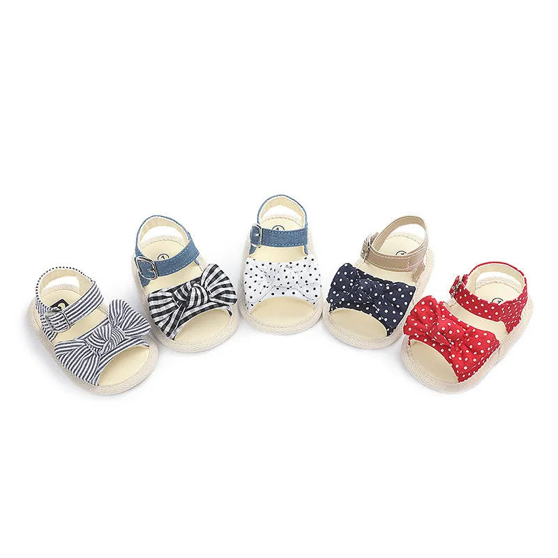 White and black toddler shoes with Velcro fastening and low tube design for babies 0-18 months