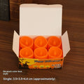 Set of six pumpkin-coloured plastic electric candle lamps arranged for Halloween decoration