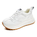 Women's beige cattlehide leather low-top casual sports shoes with cross strap and round toe.