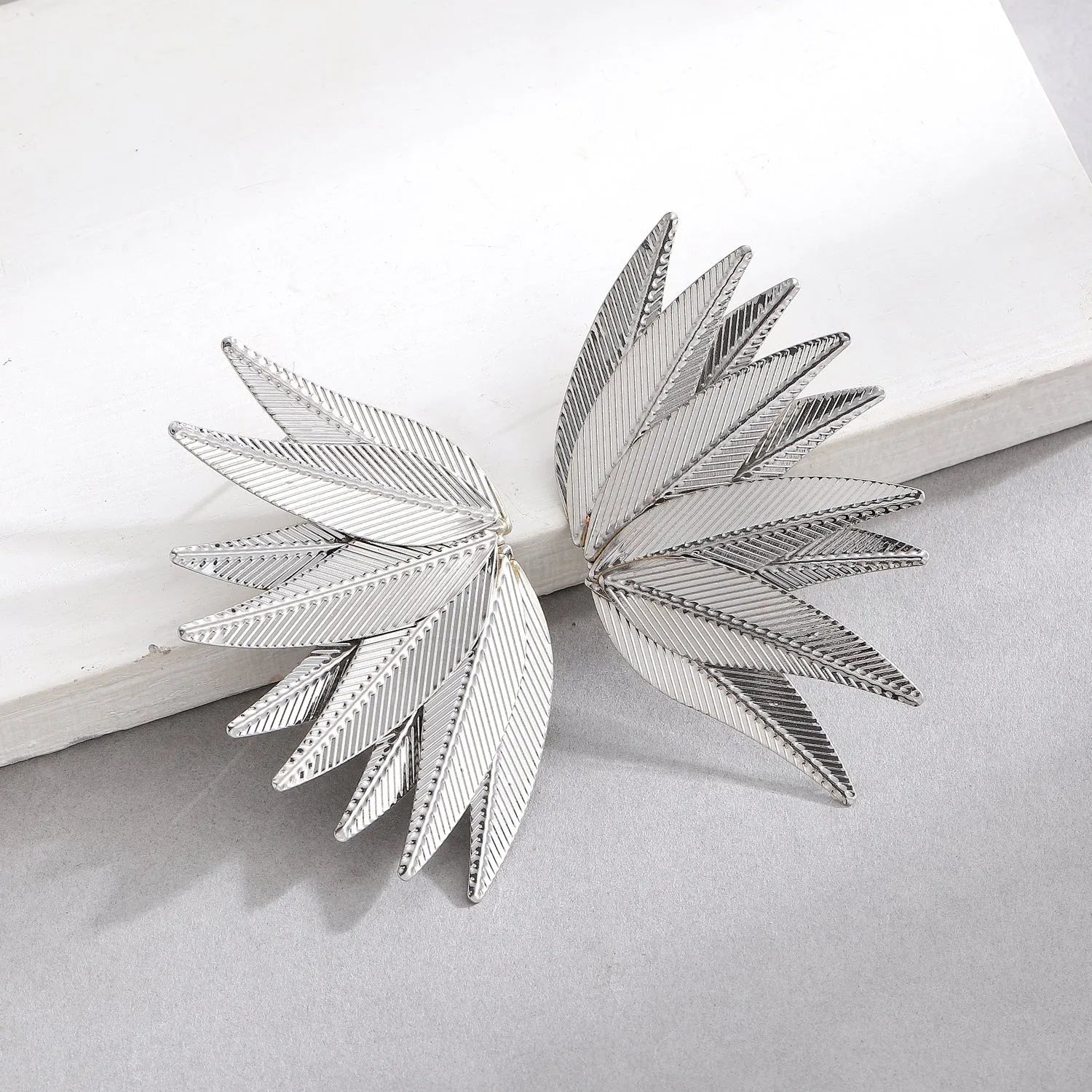 Gold and white leaves patch earrings with detailed leaf design made from alloy metal