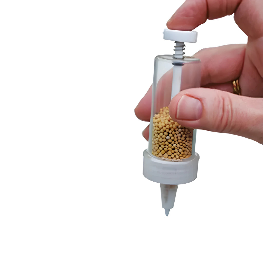 Green plastic mini garden seeder tool with adjustable thumb button, 12cm length