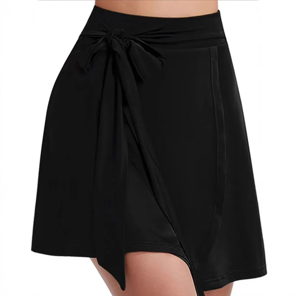 Black thigh-length sports skirt with built-in shorts, high waist design, and shoulder strap details