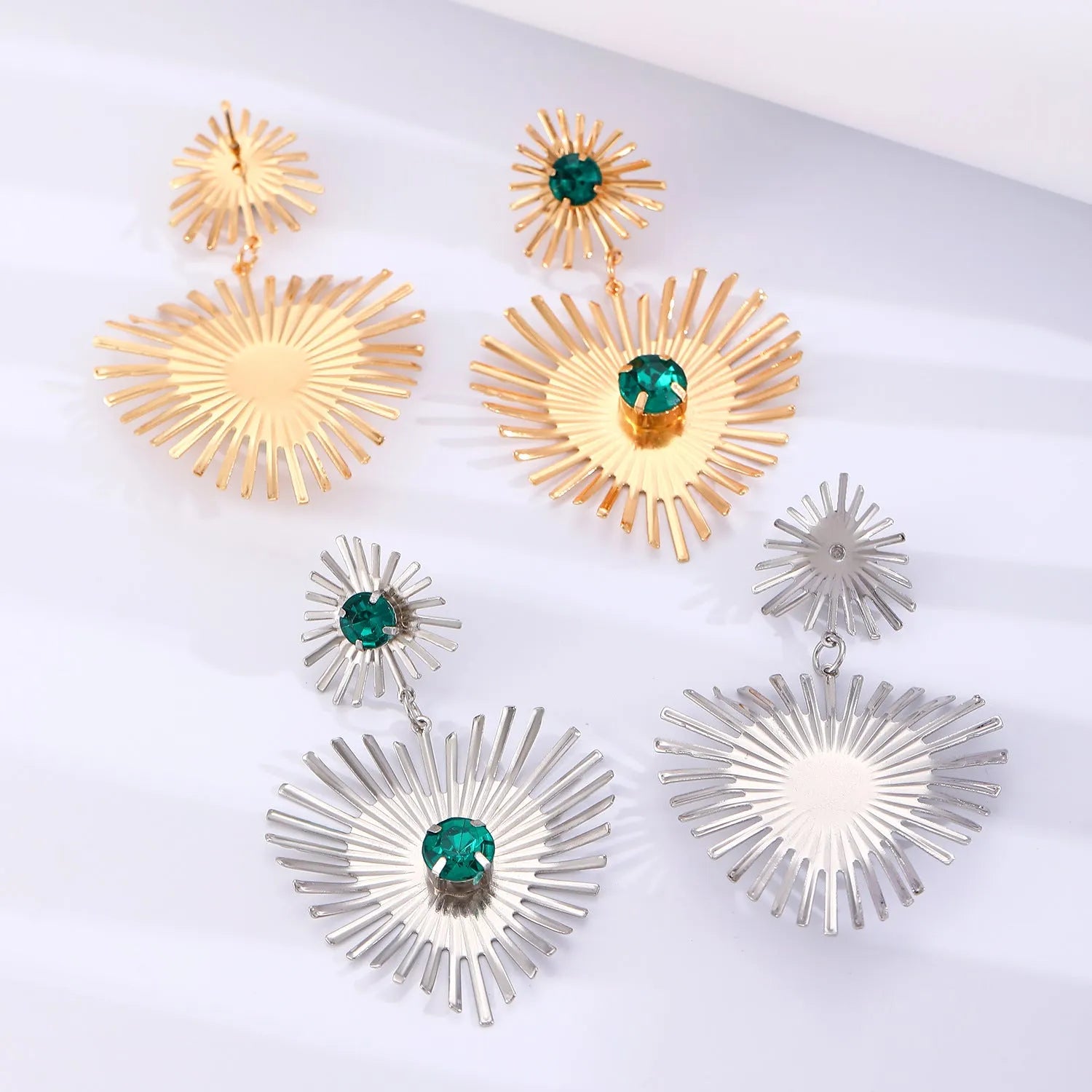 Bohemian sunflower heart-shaped earrings with rhinestones in gold finish on a white background