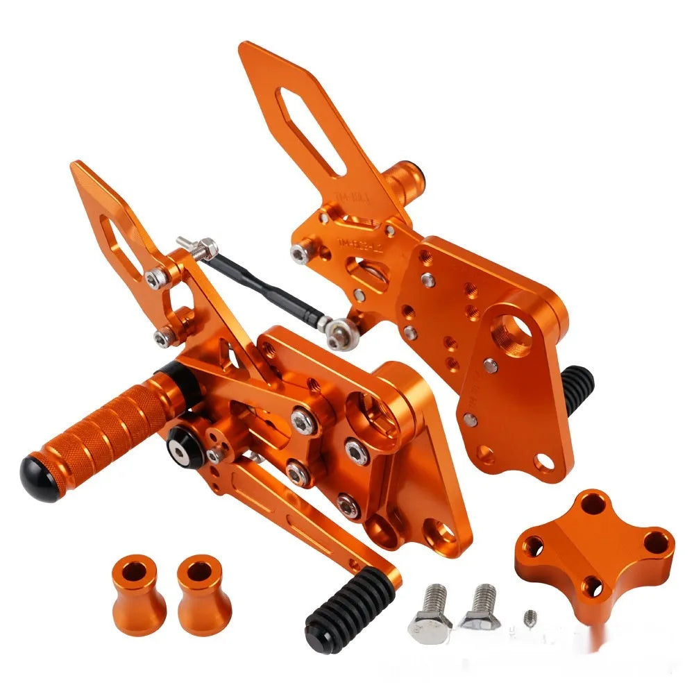 KTM Duke foot pedal bracket assembly for raised rear shift pedal in black or orange