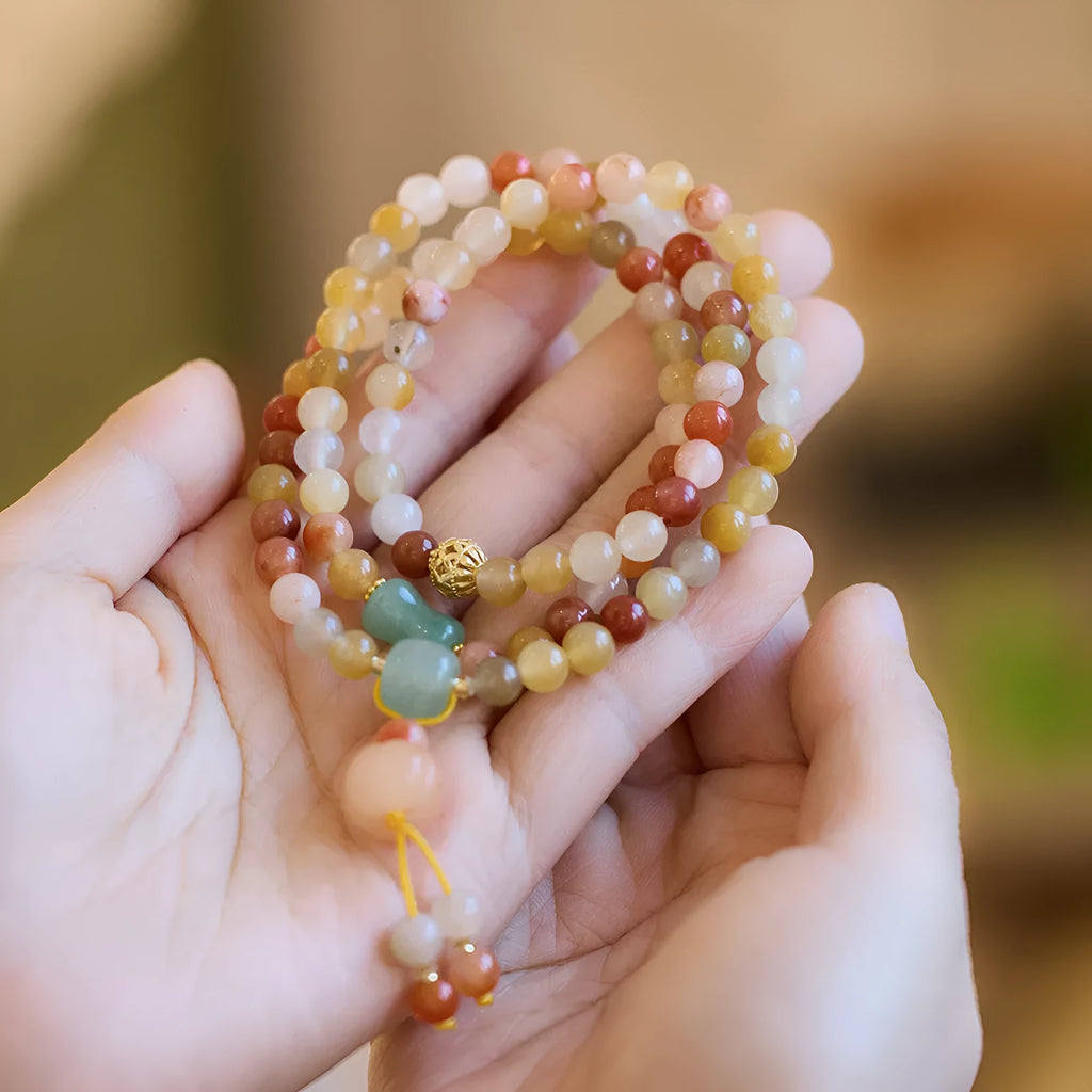 Women's Jinsi Jade bracelet with three pumpkin beads and tassel decoration on wrist