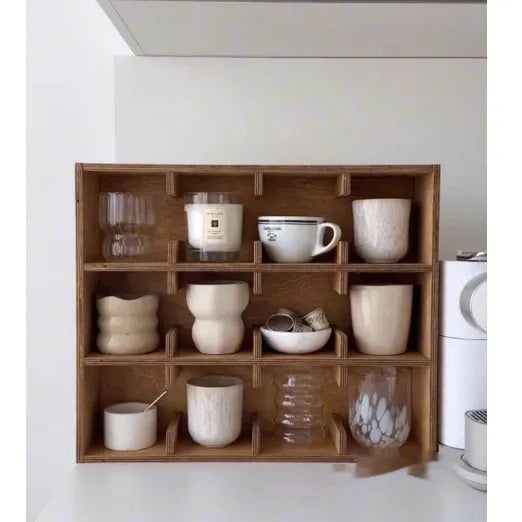 Square solid wood cup storage rack with multiple grids in natural birch wood colour.