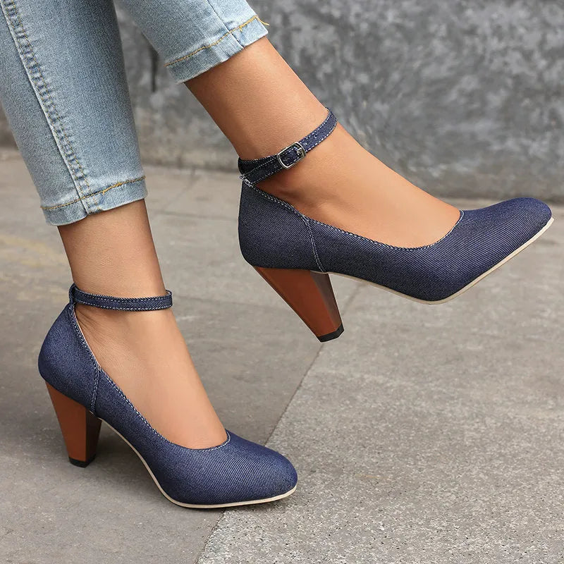 Women's blue denim platform high heels with an ankle buckle and a thick rubber sole.