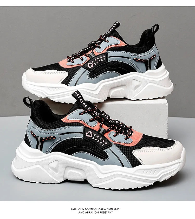 White women's casual mesh sports shoes with a thick sole, buckle detail, and round toe on a plain background.