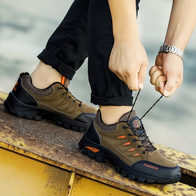 Men's brown suede mid-top hiking sneakers with rubber sole and lace-up front.