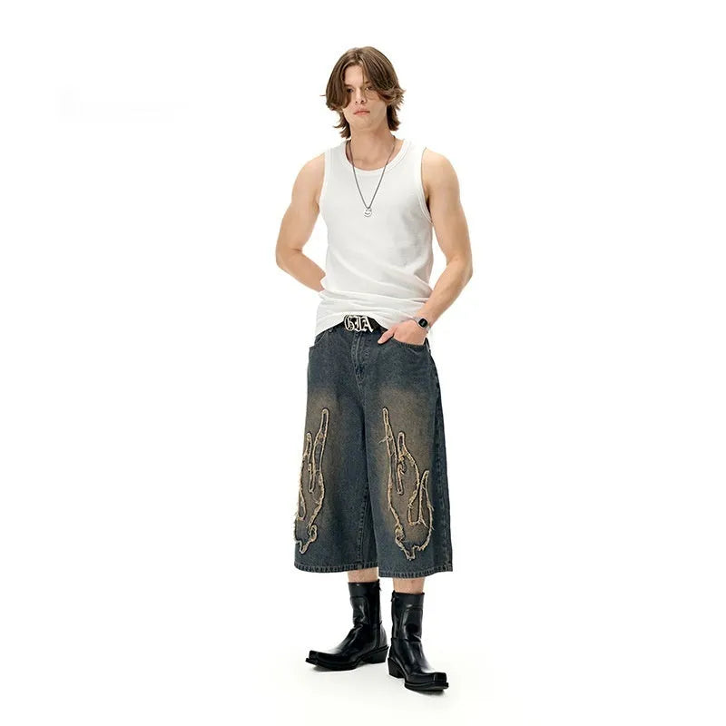 Men's cropped denim shorts with flame embroidery patch in black and blue colours, straight cut for summer street style