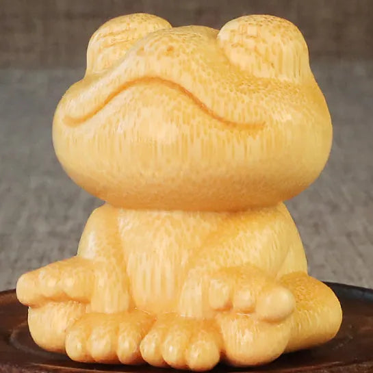 Solid bamboo smiling frog carving ornament measuring 5cm high with 120ml oil glove brush.