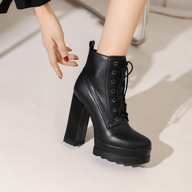 Women's black waterproof platform ankle boots with chunky heel and side zip.