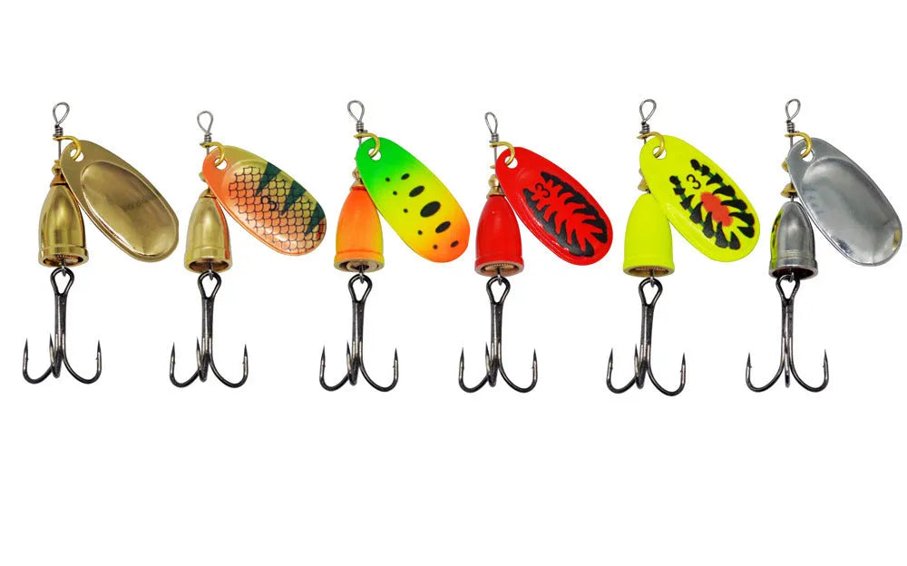R composite rotating sequin copper bell fishing lure in gold colour variant on a blue background