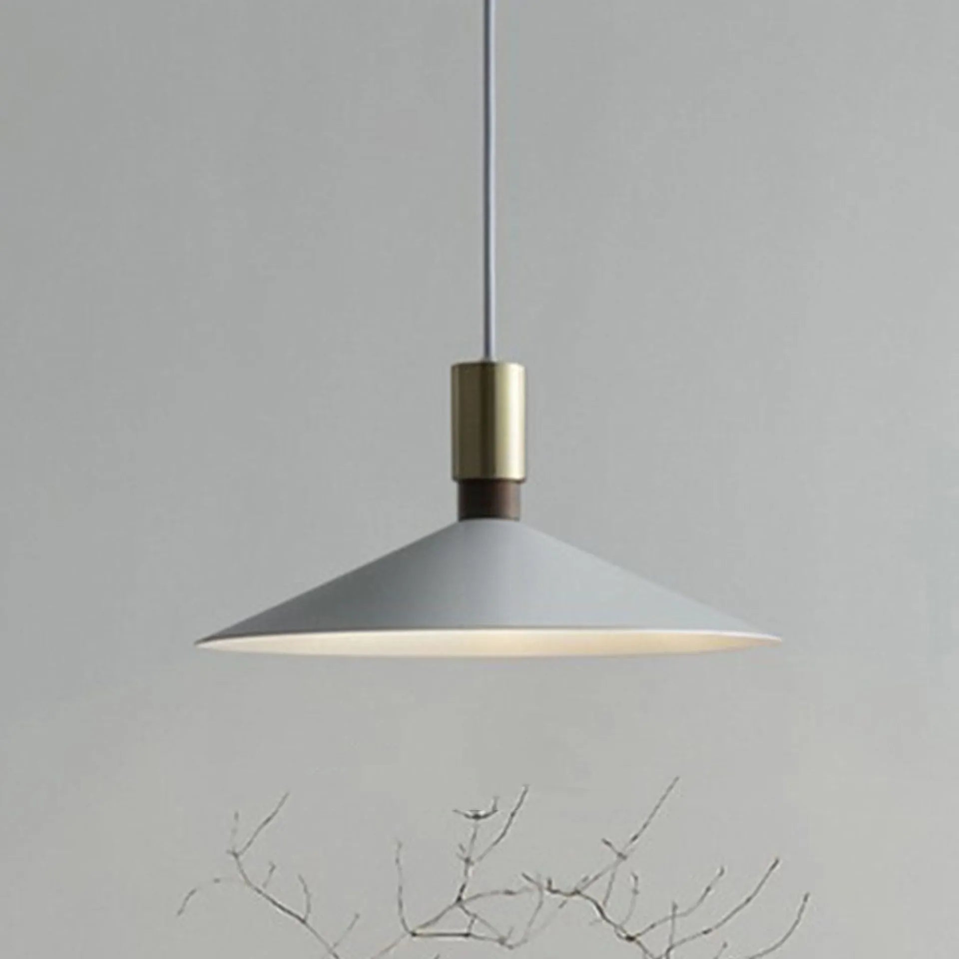 Modern round single-headed iron bar lamp in black, shown hanging over a dining table.
