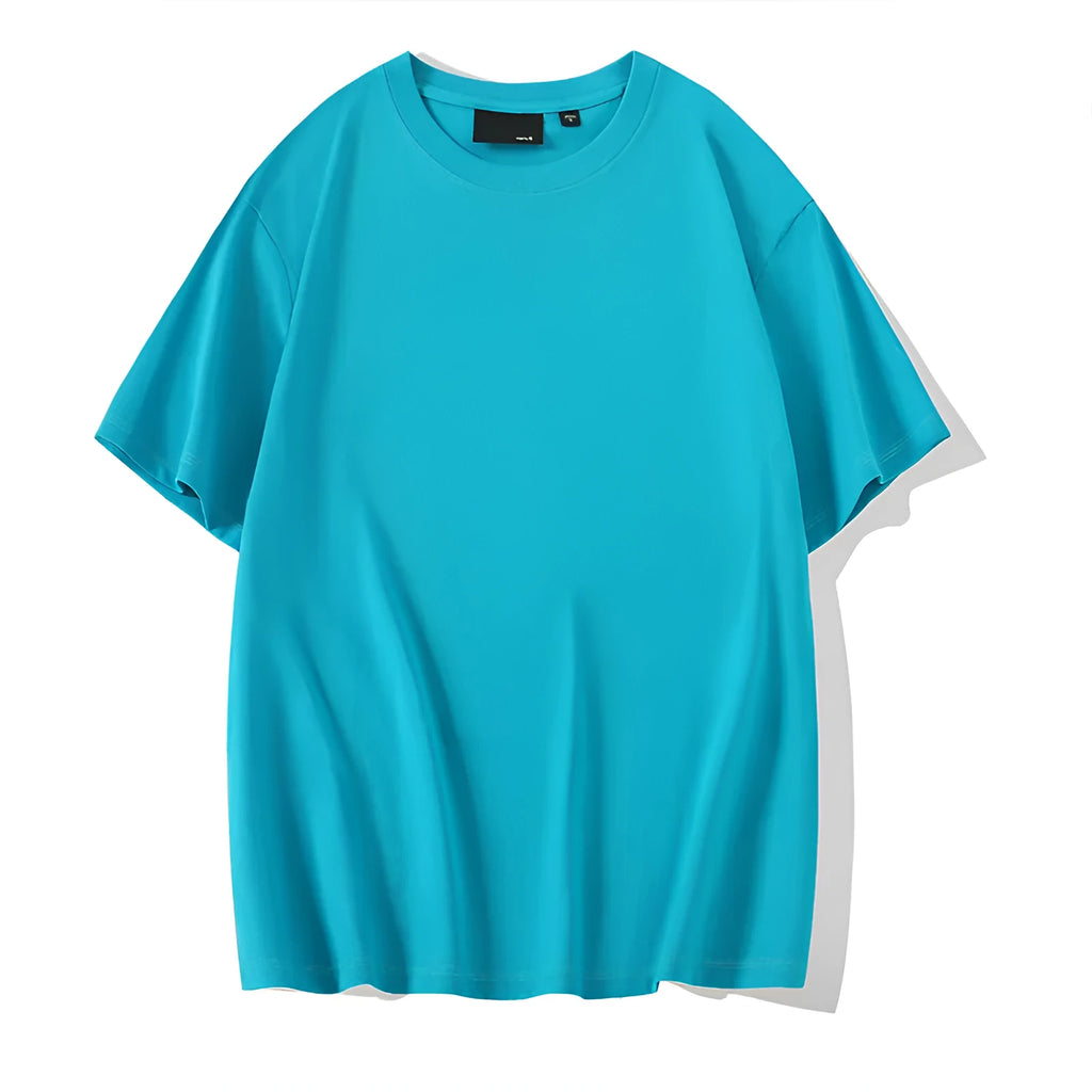 Man wearing a solid colour loose-fit cotton T-shirt with drop shoulder sleeves.