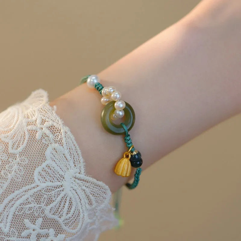 Hand-woven round watch band made from flexible wire with a Pearl Peace Buckle clasp