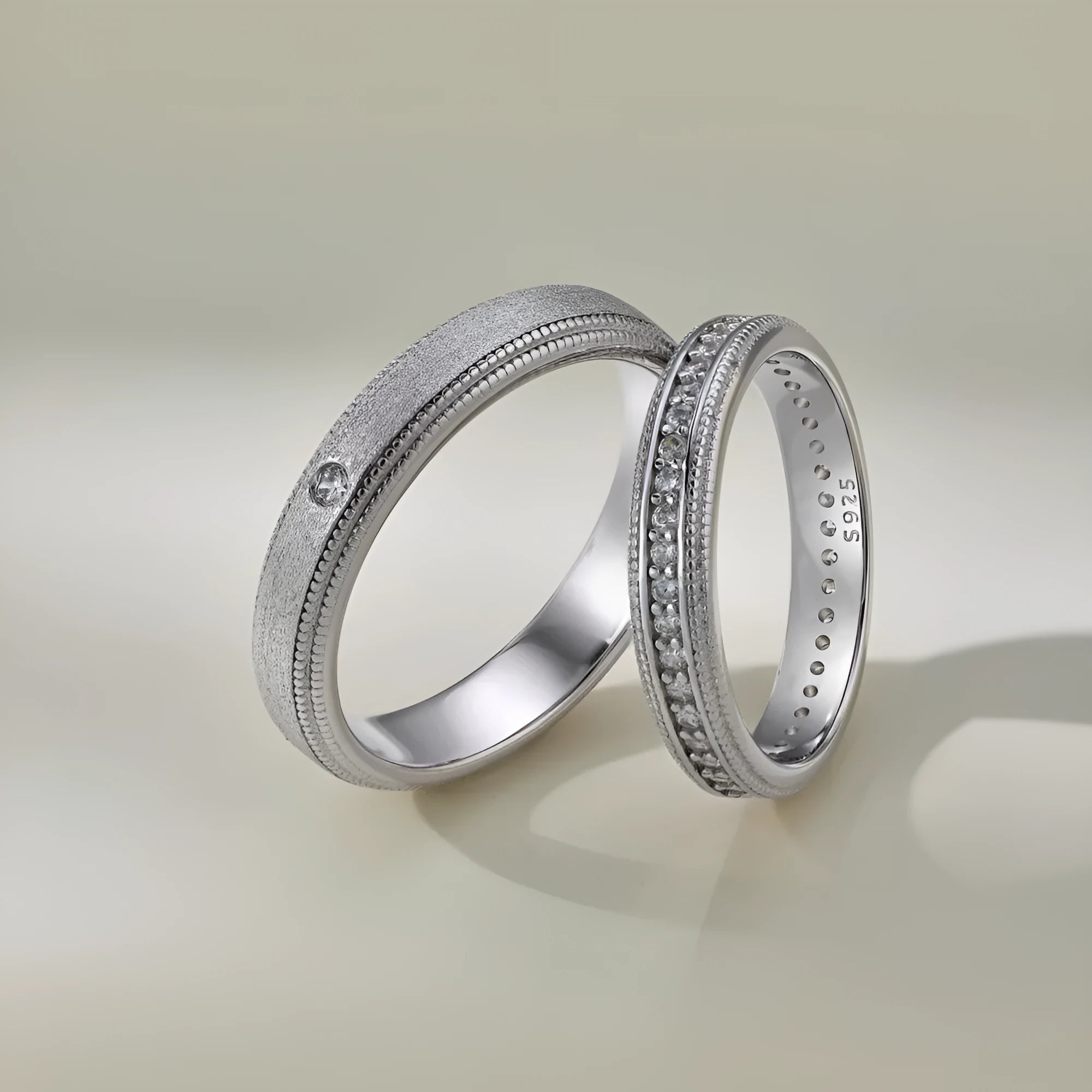 S925 sterling silver couple ring with geometric shape and platinum electroplated finish on neutral background