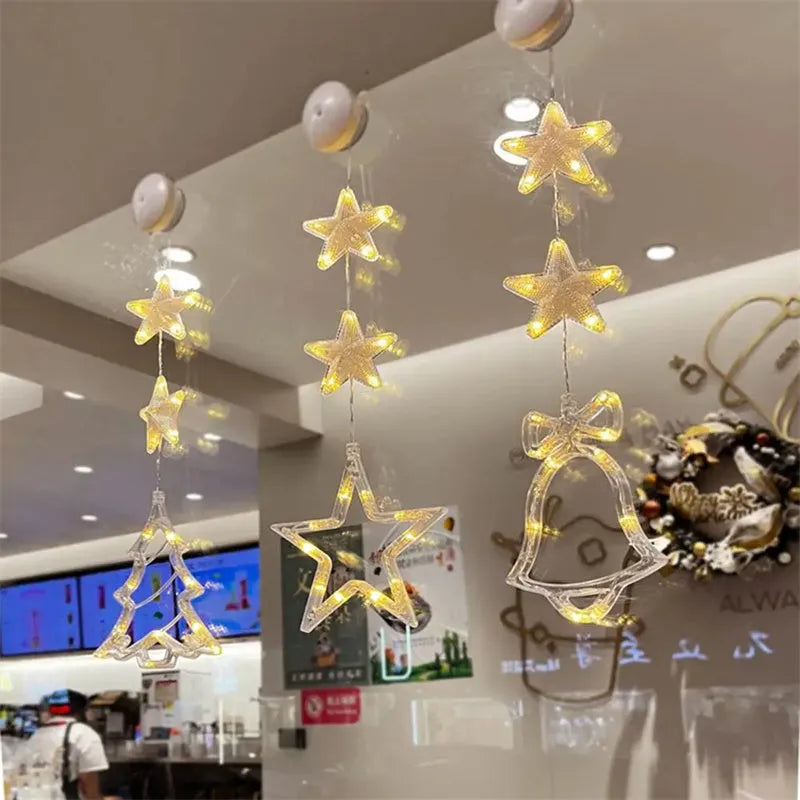 Three Christmas LED pendant lights with suction cups showing star, tree, and snowflake designs