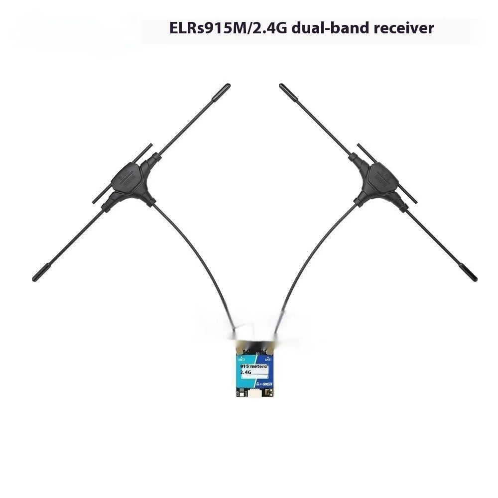 Gemini ELRS dual-frequency FPV receiver with two T-shaped antennas and installation accessories on a table.
